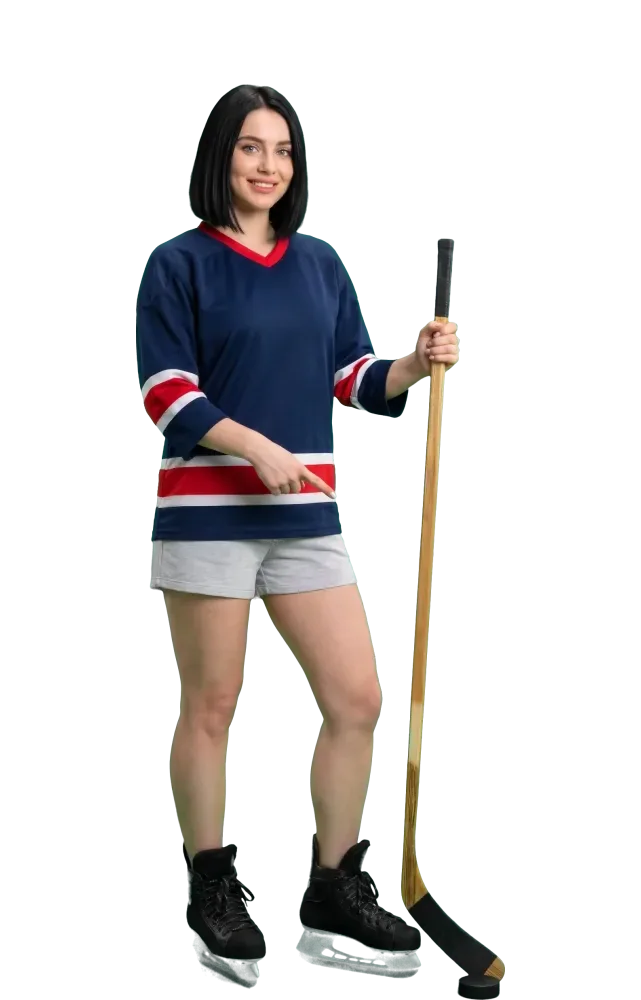 Woman pointing at a puck by the blade of her stick