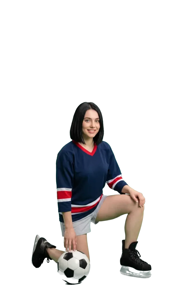 Woman kneeling with her hand on a soccer ball